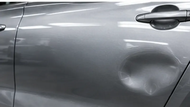 Dent being repaired on a car panel